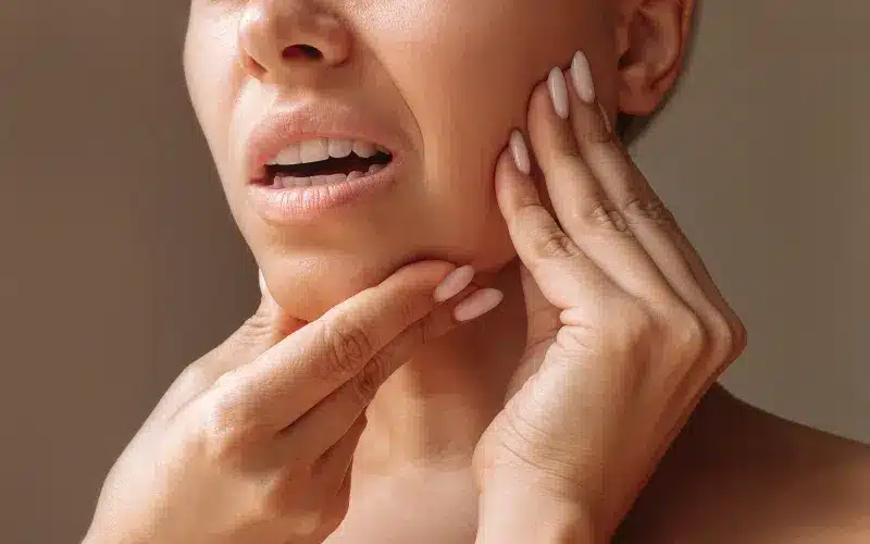 Adult touching their jaw